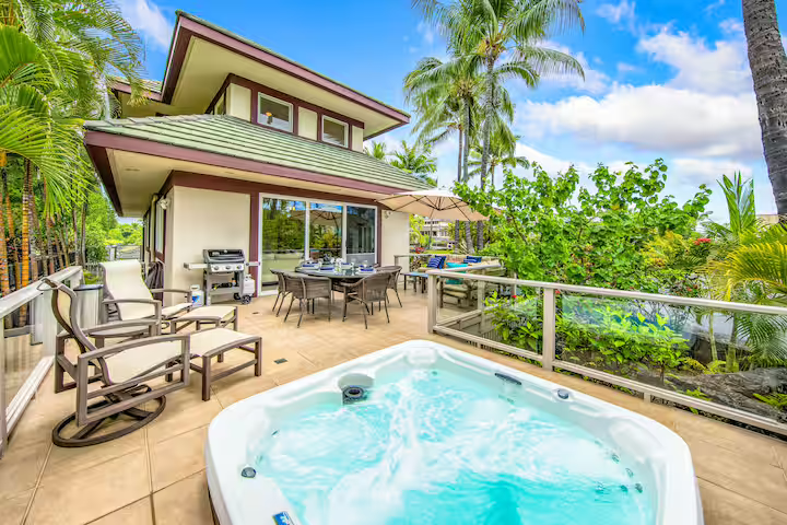 Private hot tub on main lanai with tropical garden views