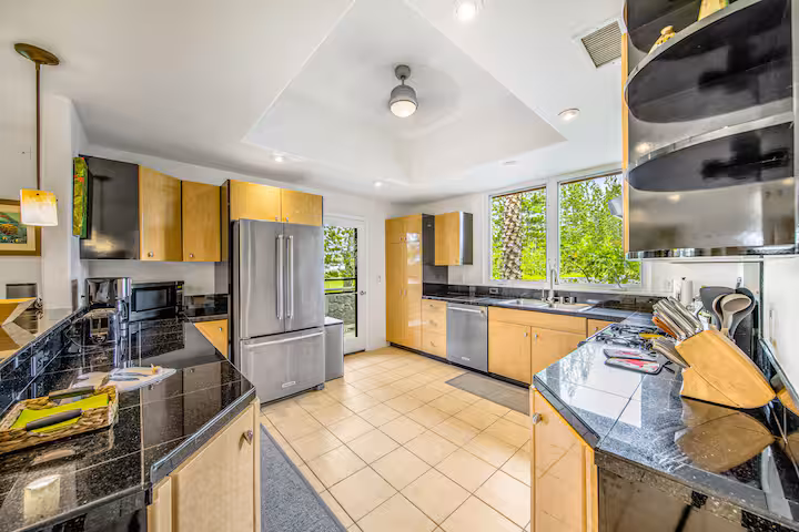 Fully equipped kitchen with granite countertops and modern appliances