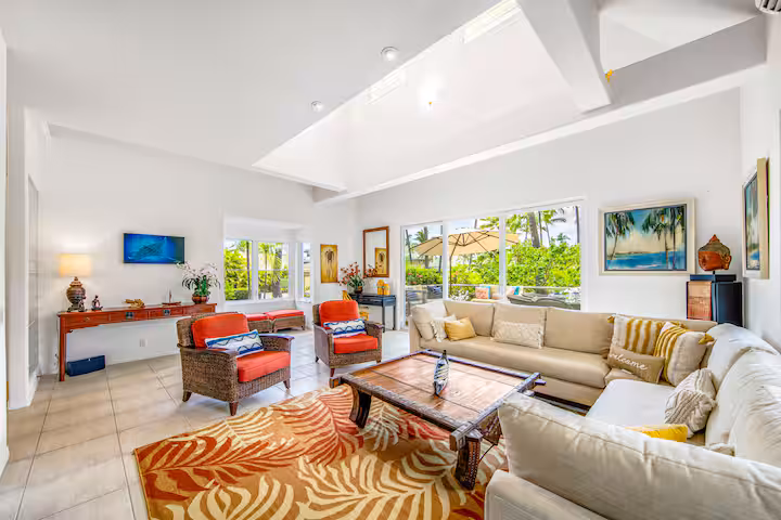 Living room area showing off high ceilings and garden views