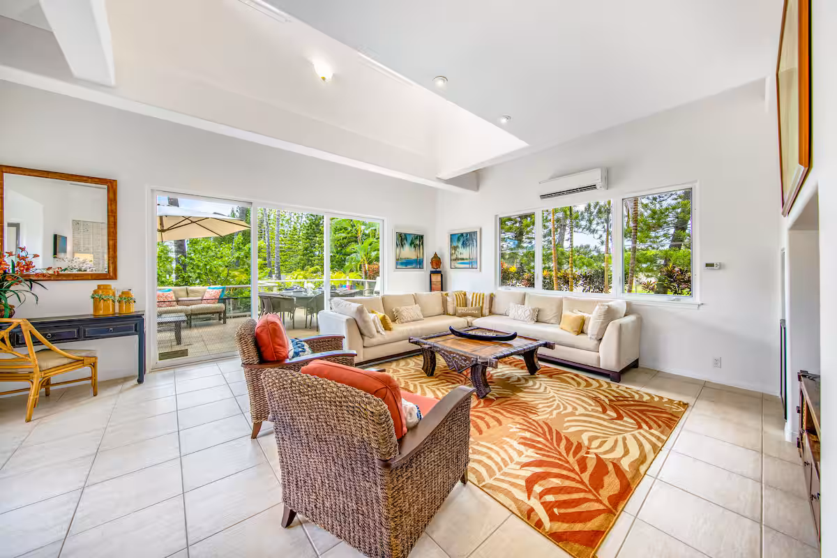 Spacious living area with comfortable seating and tropical styling