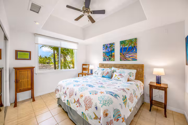 Comfortable guest bedroom with modern furnishings and tropical decor